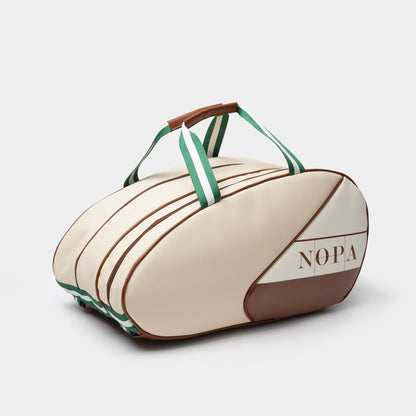 NOPA cream padel racket bag with tan trim and green-white striped handles, front angle view